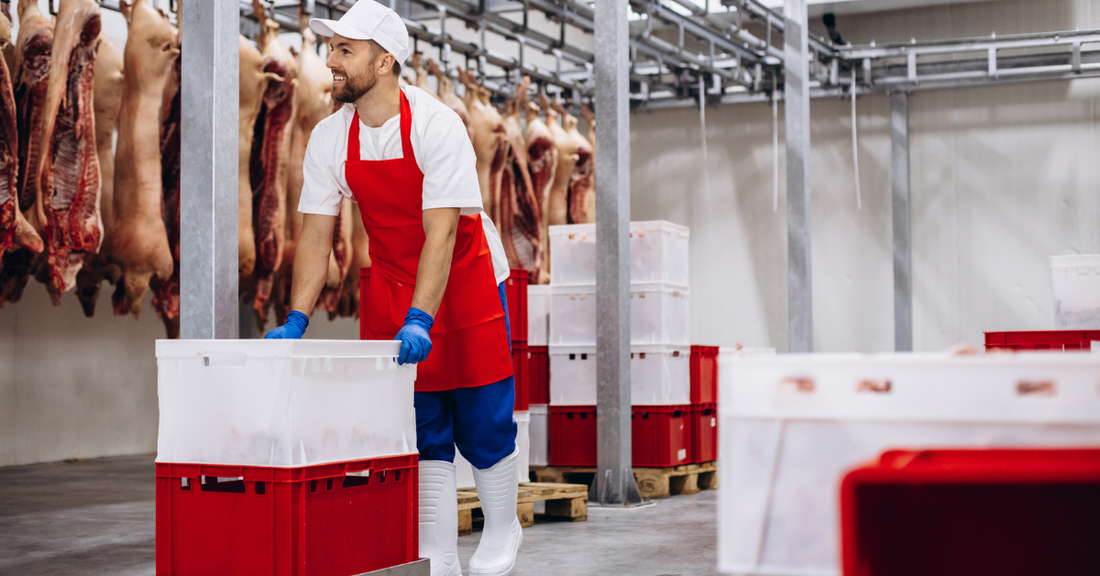 Man pushing boxes in a meat processing plant